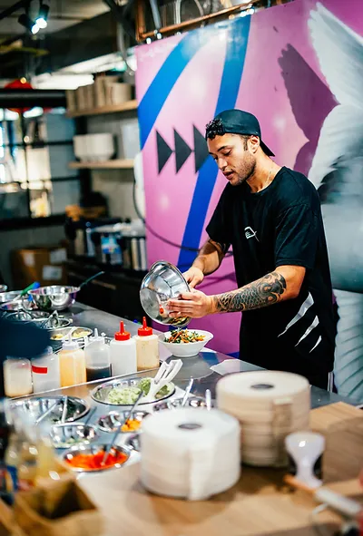 The co-founder of Ika Bowl making a bowl for a customer